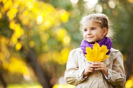 142492-425x282-girl-holding-fall-leaves-2416201